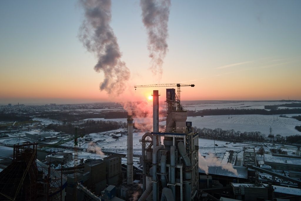 aerial-view-of-cement-factory-with-high-concrete-plant-structure-and-tower-crane-at-industrial-production-area-in-evening-manufacture-and-global-industry-concept.jpg